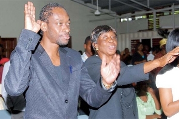 Bounty Killer follows Miss Ivy to church.